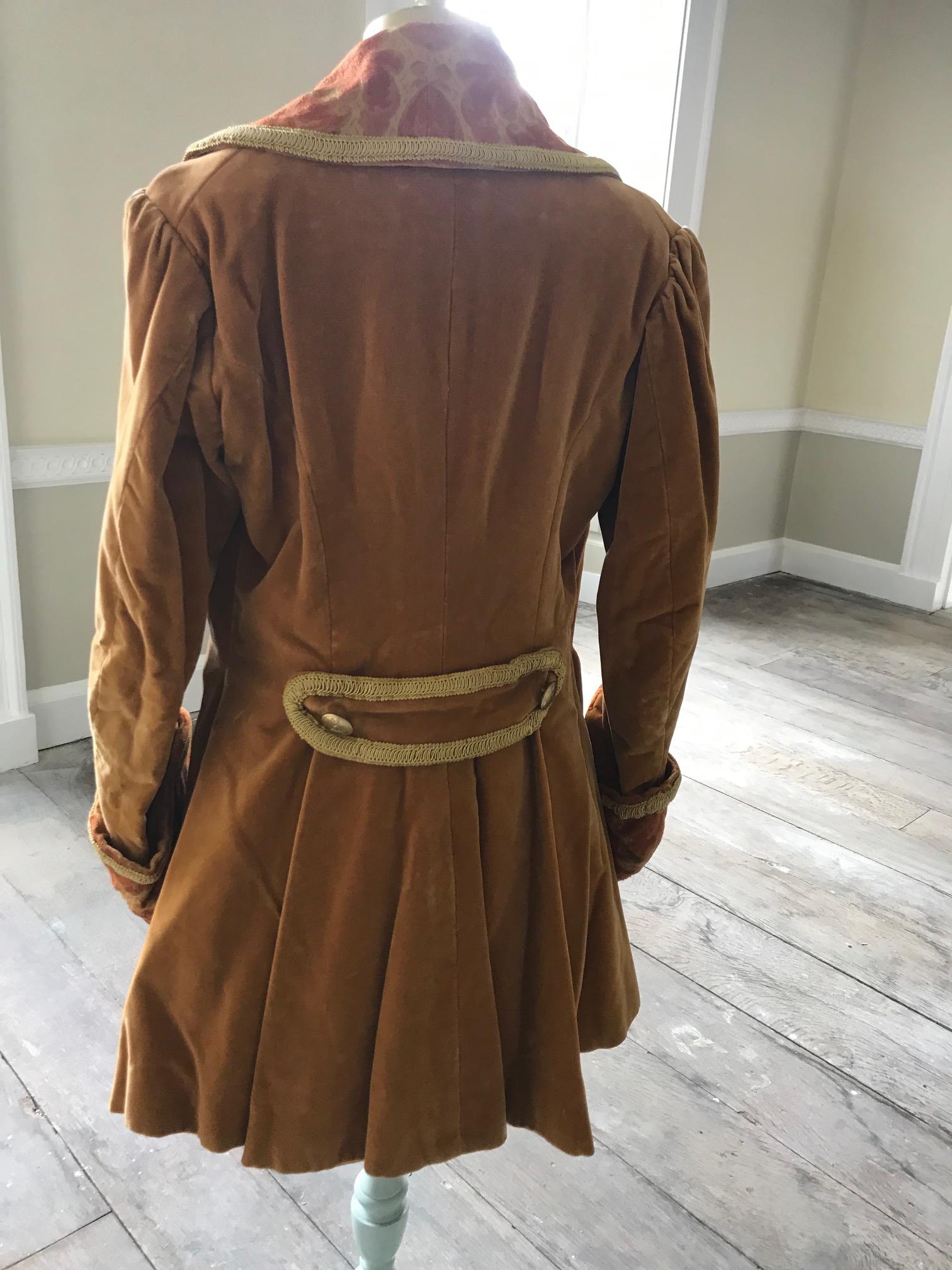 A man's 19th century smoking jacket, mustard velvet, with brocade lapels and cuffs. Ex Royal Opera House 'Arabella'